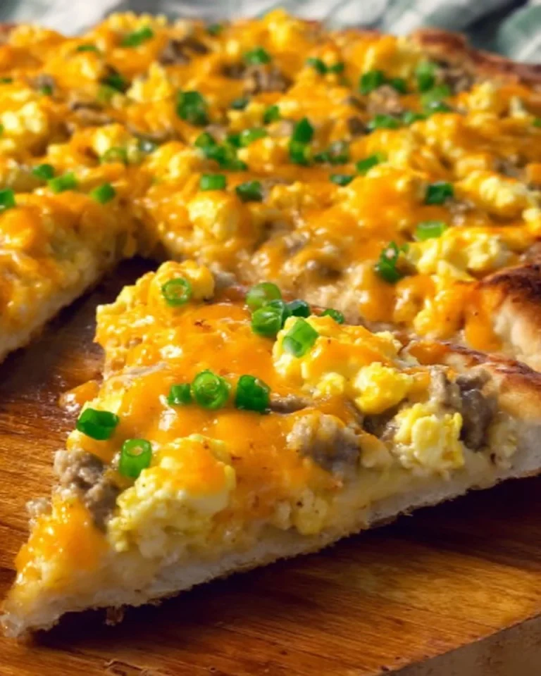 Sausage gravy breakfast pizza topped with savory sausage and creamy gravy