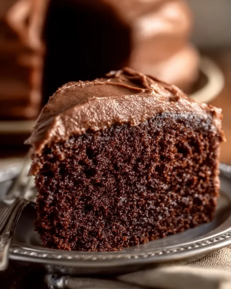 Slice of moist Chocolate Mayonnaise Cake topped with chocolate frosting
