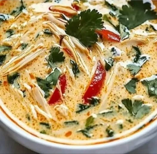 Crockpot Thai Coconut Chicken Soup garnished with herbs and lime slices