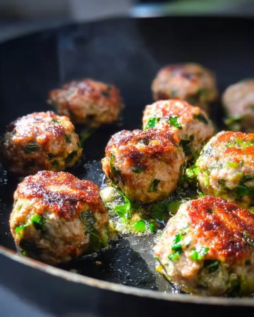 Easy low carb high protein meatballs served on a plate with herbs