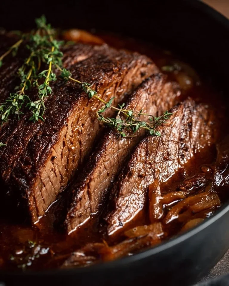 Delicious slow cooker beef brisket served on a platter with herbs