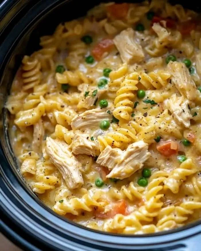 Delicious Slow Cooker Chicken Pot Pie Pasta served in a bowl with fresh herbs