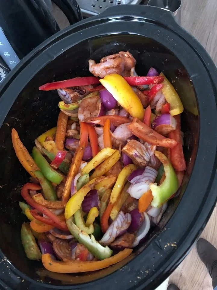 Delicious Slow Cooker Fajitas served with fresh toppings and sides.