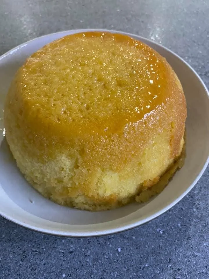 Delicious slow cooker sponge pudding served in a bowl with a spoon