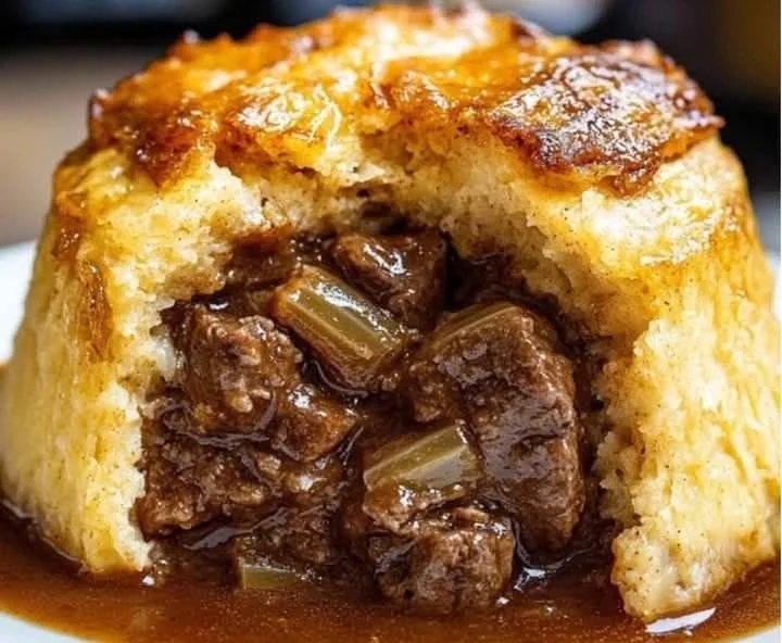 Delicious Steak and Onion Suet Pudding served with gravy