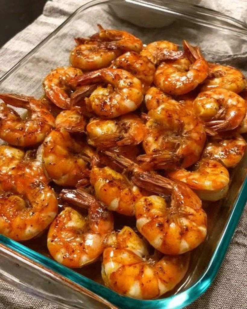 Crispy air fryer shrimp served with dipping sauce on a plate.