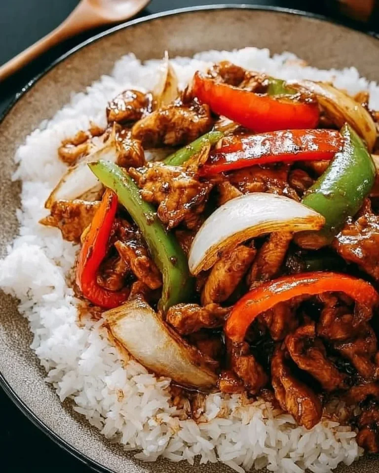 Plate of flavorful black pepper chicken garnished with vegetables