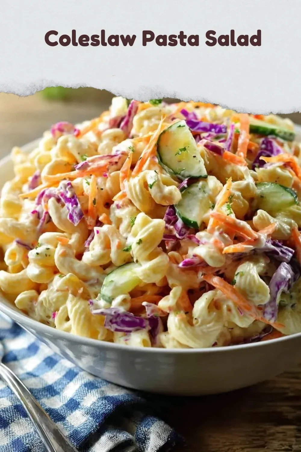 Bowl of coleslaw pasta salad with colorful vegetables and dressing