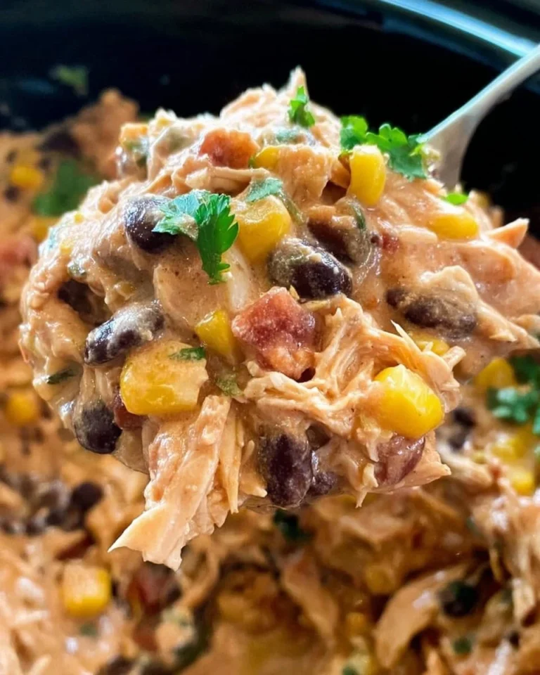 A bowl of Crock Pot Fiesta Chicken with colorful peppers and spices.