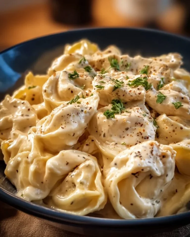 Crockpot Chicken Alfredo Tortellini dish with creamy sauce and herbs