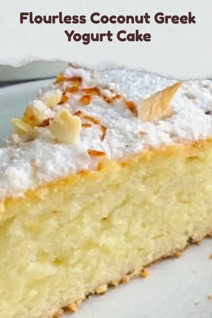 Flourless Coconut Greek Yogurt Cake topped with coconut flakes and berries