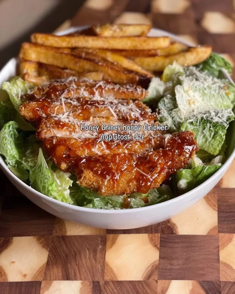 Healthy Chicken Caesar Salad with crispy fries served on a plate.