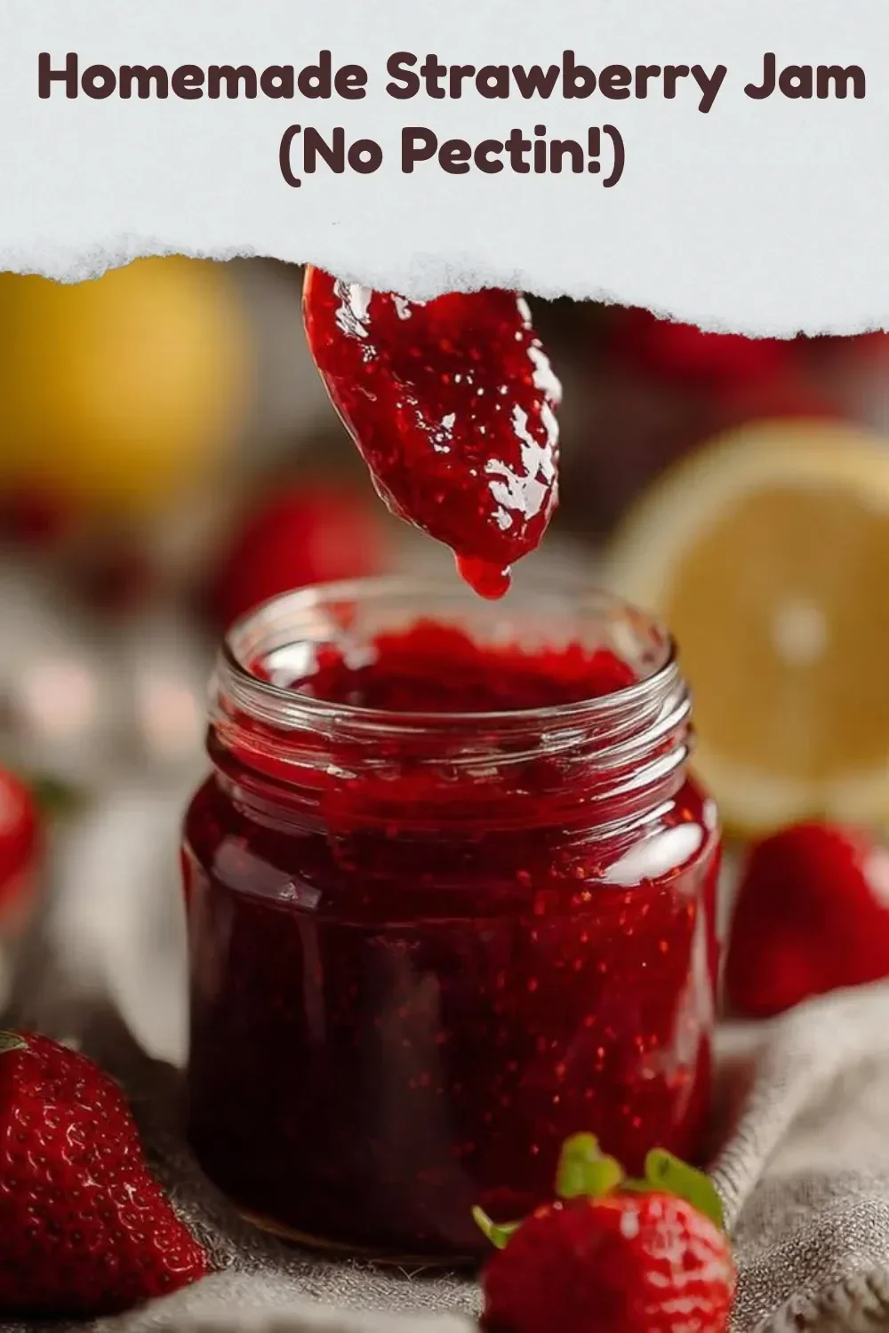 A jar of homemade strawberry jam made without pectin, with fresh strawberries on the side.