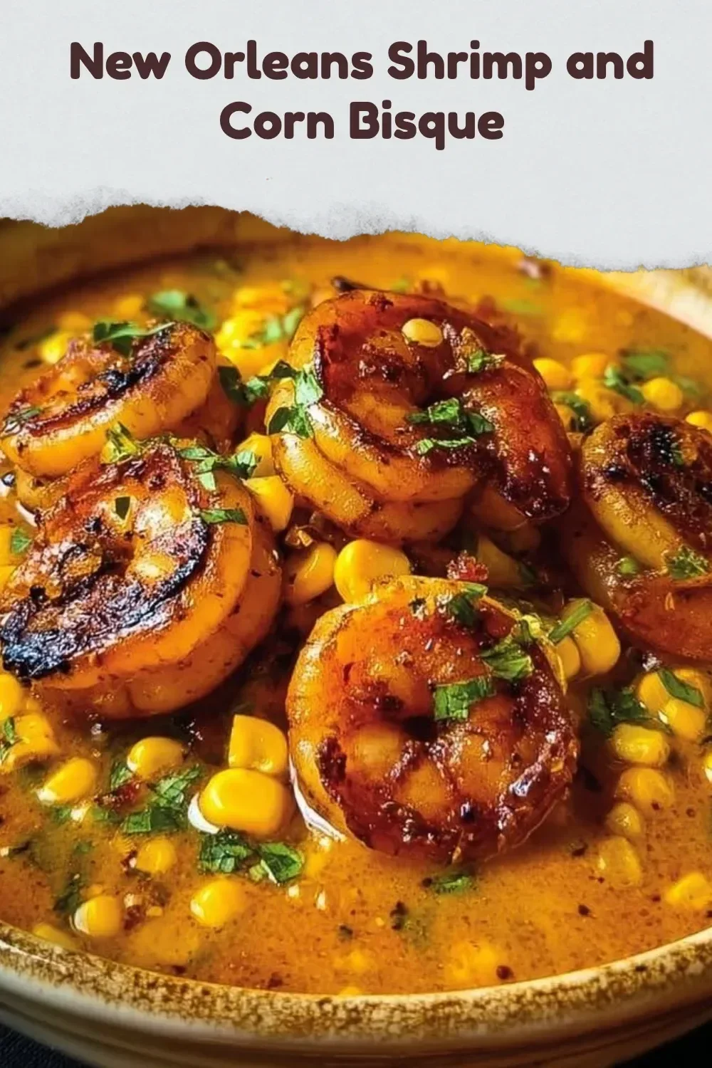 Bowl of creamy New Orleans shrimp and corn bisque garnished with herbs