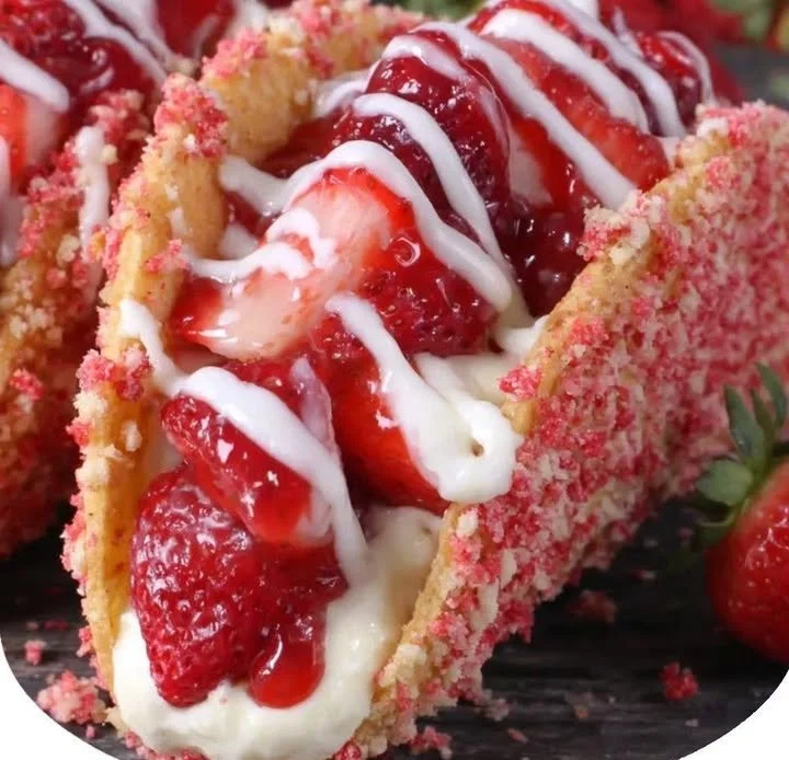 Strawberry crunch cheesecake tacos served on a plate
