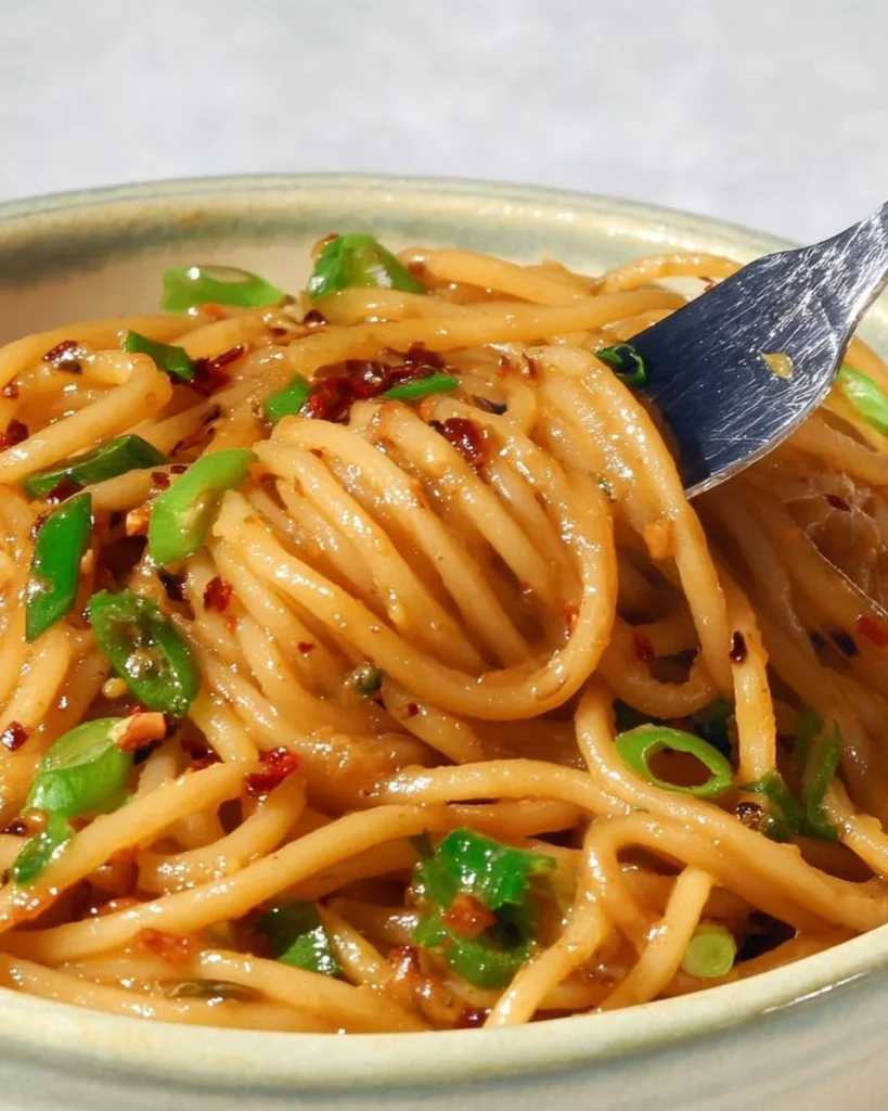 Delicious vegan garlic noodles served in a bowl with fresh herbs