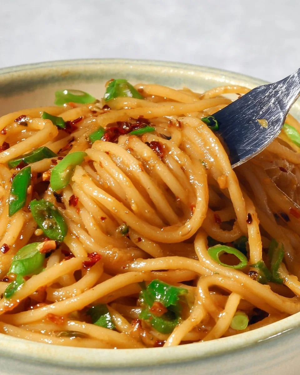 Delicious vegan garlic noodles served in a bowl with fresh herbs