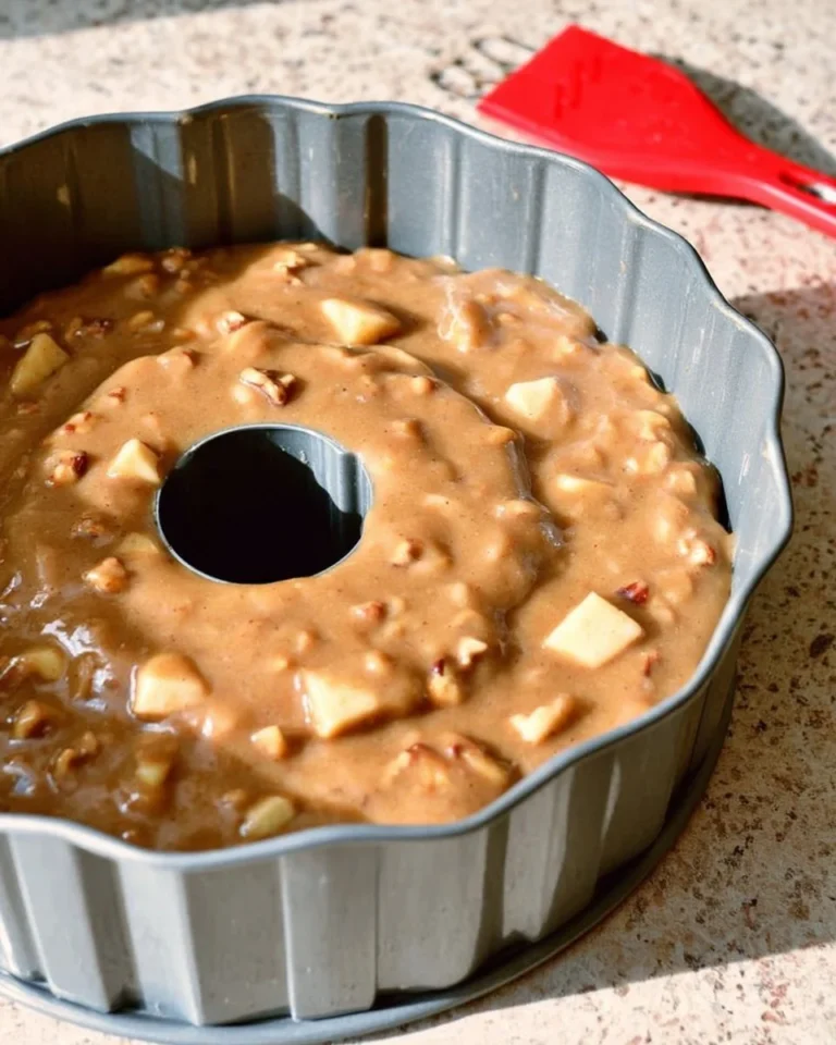 Delicious homemade apple cake topped with fresh apples and spices.