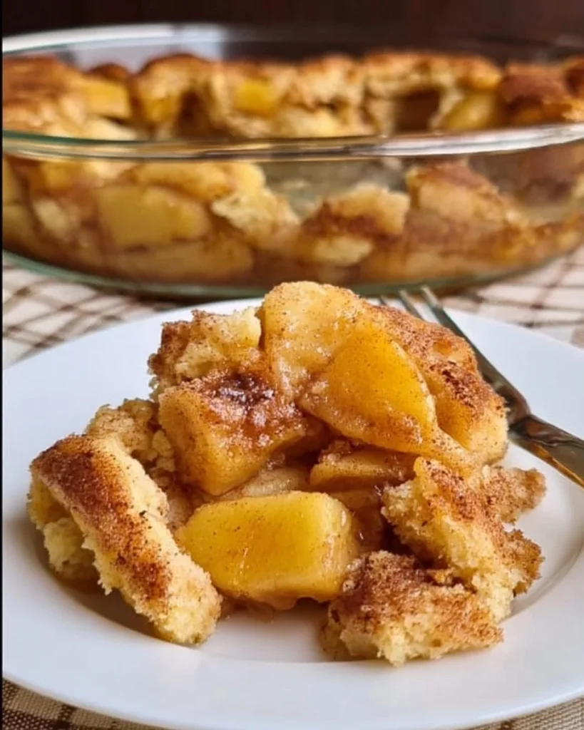 Homemade apple cobbler with apples and crispy topping served in a baking dish.