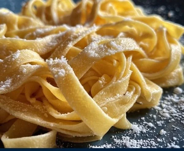 Plate of freshly made Italian homemade pasta garnished with herbs