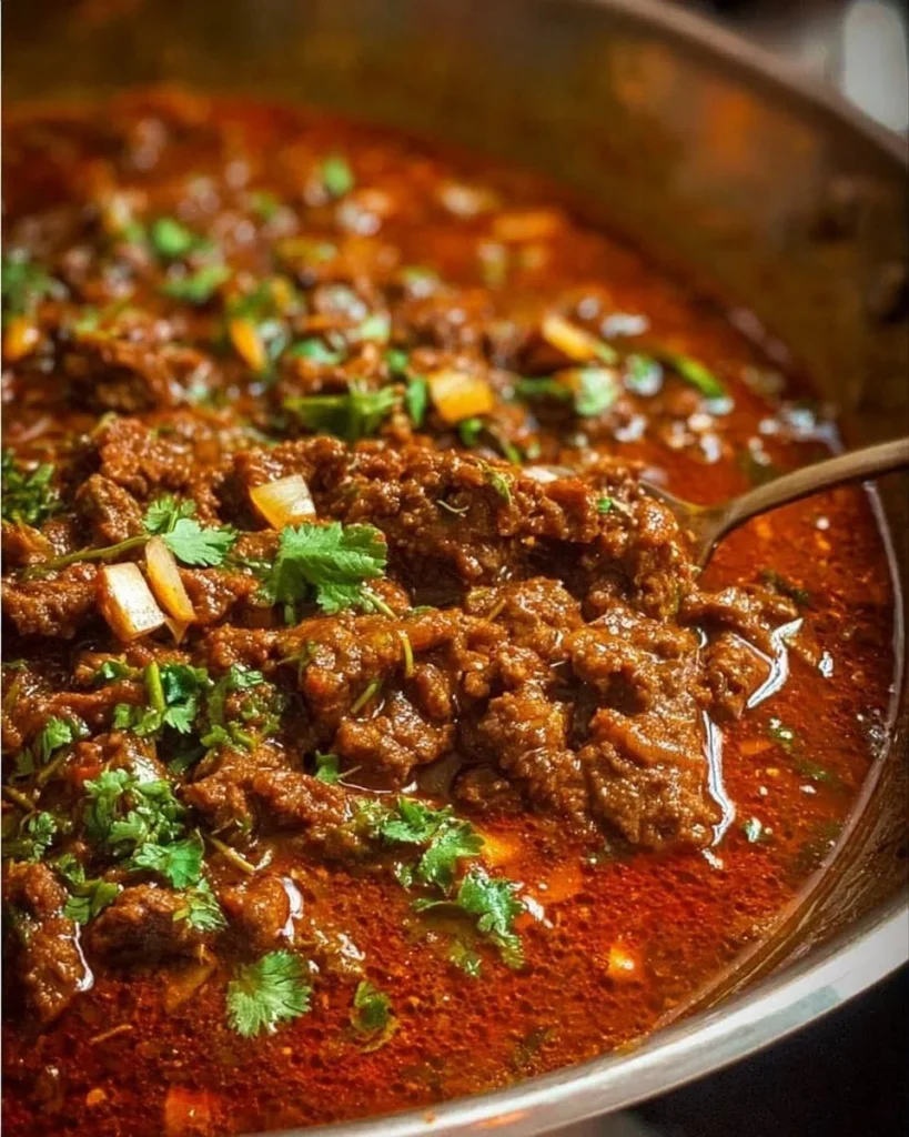 Delicious beef curry served in a bowl garnished with fresh herbs