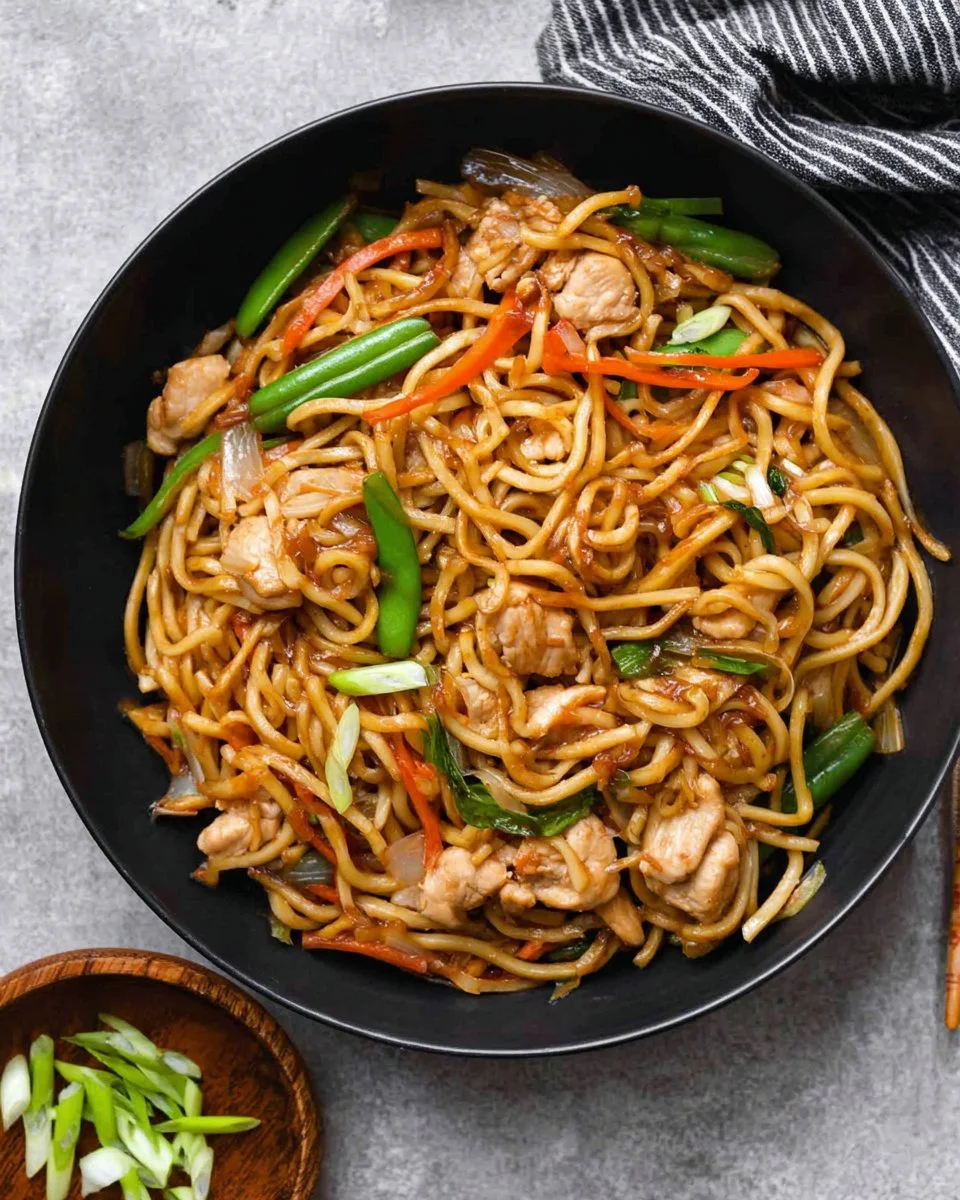 Delicious Chicken Chow Mein served with fresh vegetables and chicken strips
