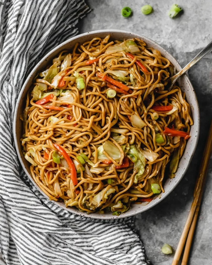 Delicious Chow Mein stir-fried noodles topped with fresh vegetables and proteins.