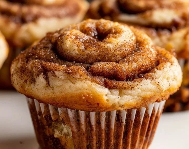 Healthy Cinnamon Roll Protein Muffins fresh from the oven on a wooden table