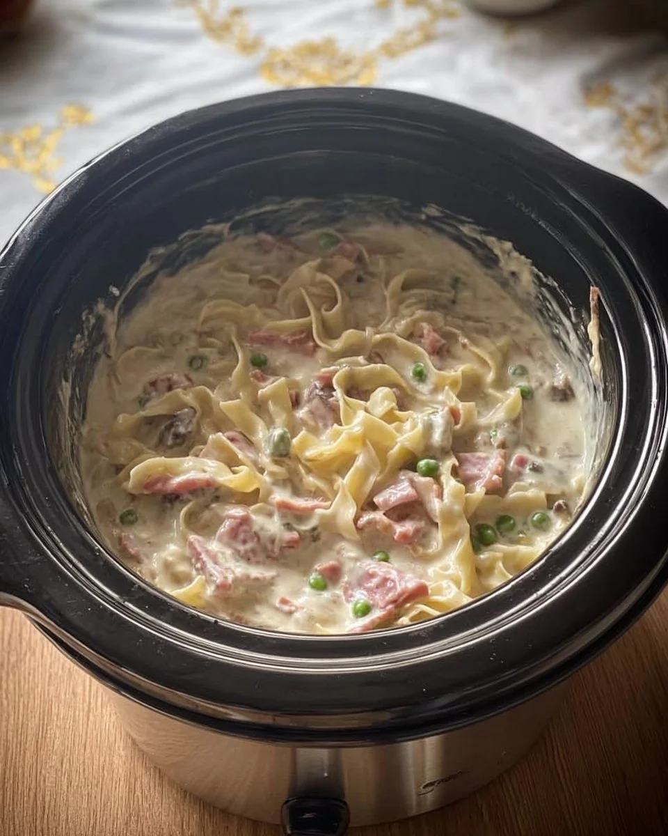 A delicious plate of creamy Chicken Carbonara topped with parsley and parmesan.