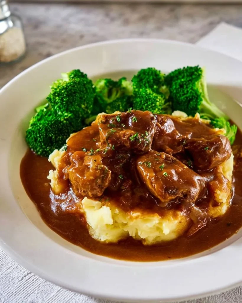 Crockpot beef tips with rich gravy served on a plate