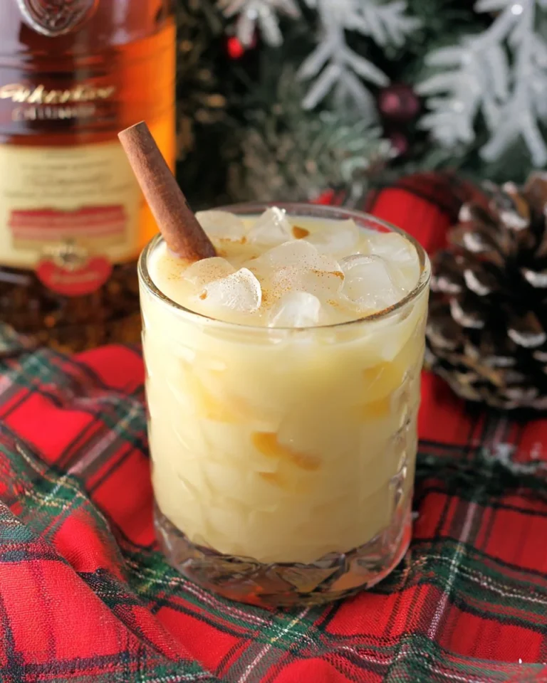 Eggnog Amaretto cocktail topped with nutmeg and festive garnishes