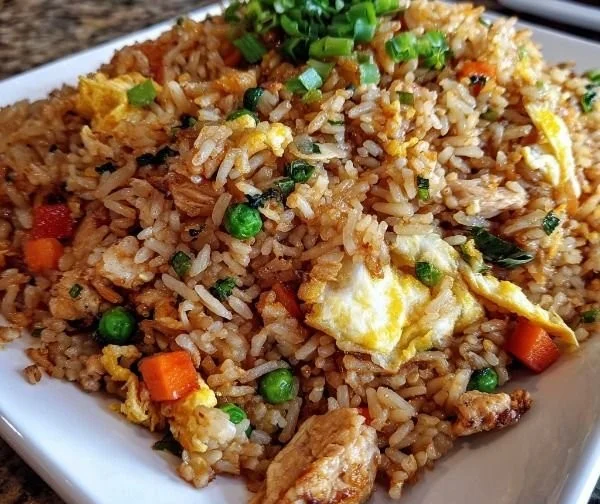 Plate of ground chicken fried rice with vegetables and herbs