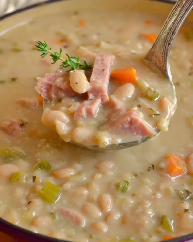 Bowl of homemade Ham and Bean Soup garnished with fresh herbs