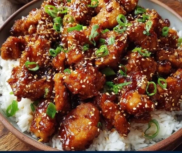 Delicious honey sesame chicken served with vegetables and rice