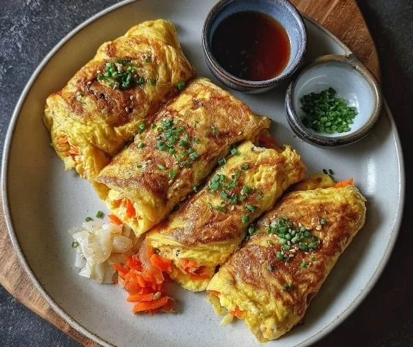 Korean rolled omelette sliced and garnished on a plate