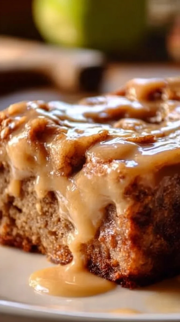 Delicious slice of Apple Dapple Cake topped with walnuts and drizzled with caramel