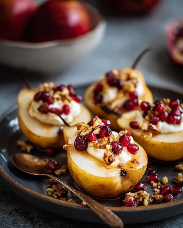 Delicious baked pears with whipped ricotta, hazelnut, and cranberry crunch topping.
