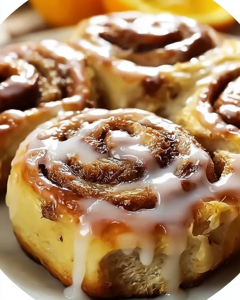 Freshly baked banana bread cinnamon rolls topped with creamy glaze