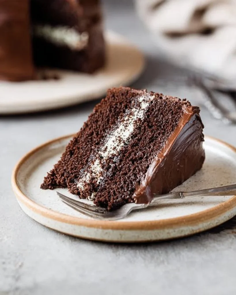 Delicious Chocolate Oreo Cheesecake topped with crushed Oreos and chocolate drizzle
