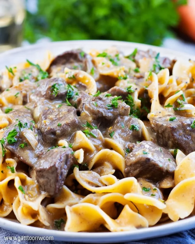 Delicious Instant Pot Beef Stroganoff served in a bowl with garnish.