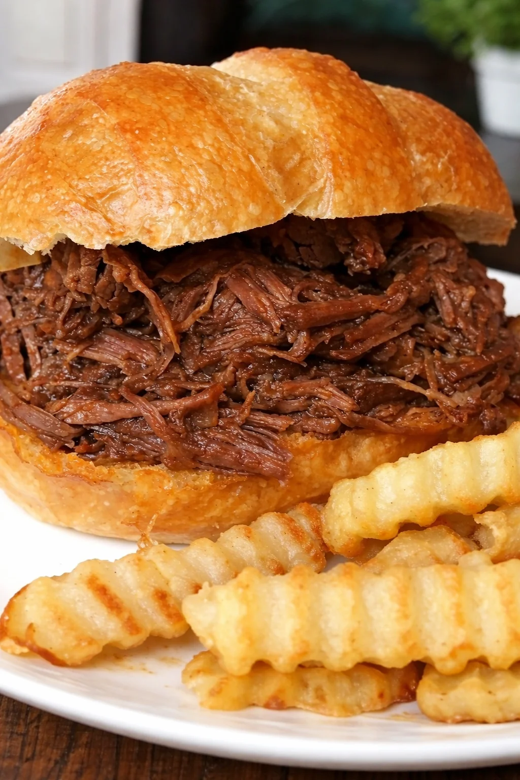 Slow cooker BBQ beef sandwiches with toppings on a platter