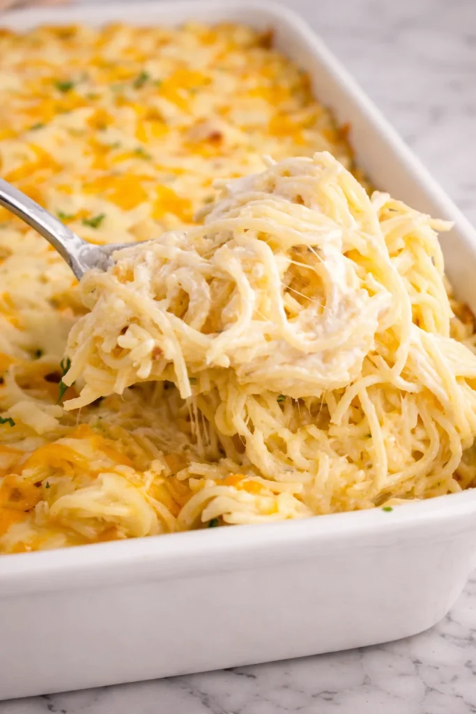 Delicious Chicken Tetrazzini pasta dish topped with melted cheese and fresh herbs.