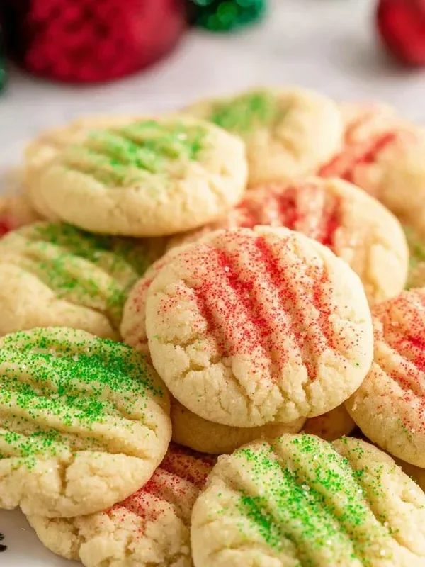 A tray of classic Christmas cookies decorated with icing and sprinkles.