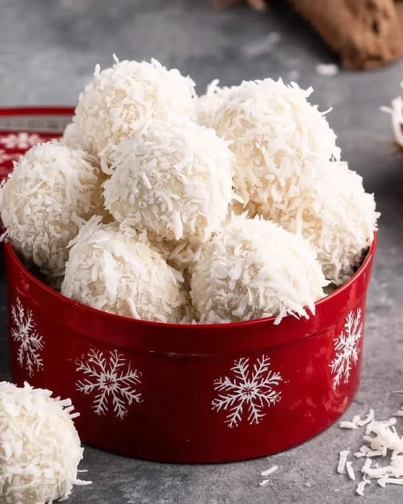 Homemade Coconut Snowballs coated in shredded coconut, a delicious dessert.