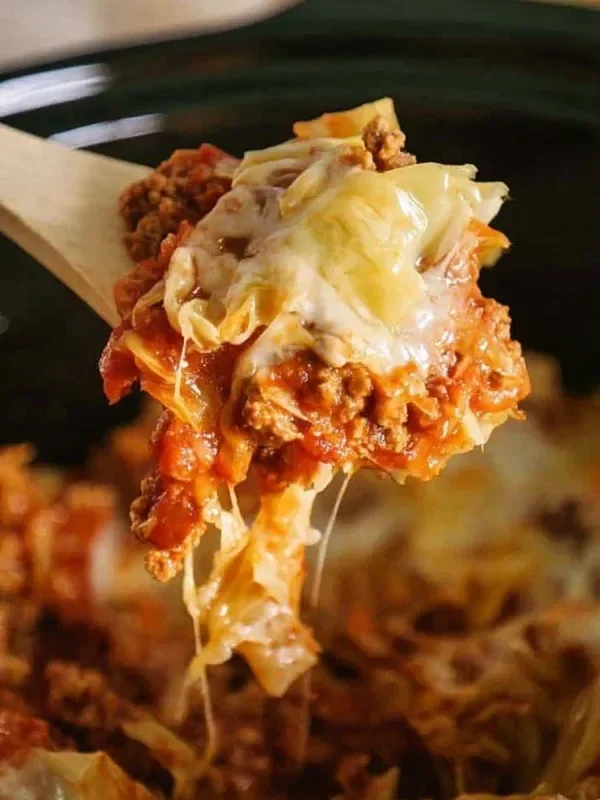 Crock Pot cabbage roll casserole with layers of cabbage, meat, and rice