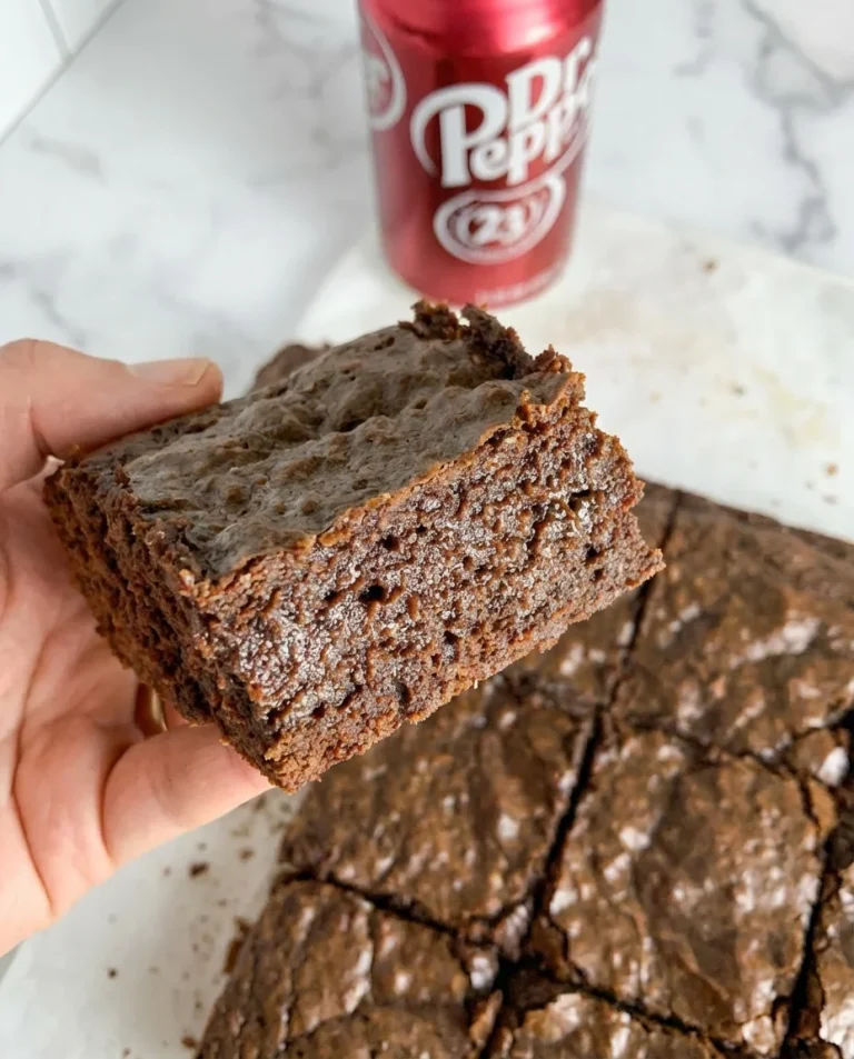 Delicious Dr Pepper brownies topped with chocolate and Dr Pepper syrup