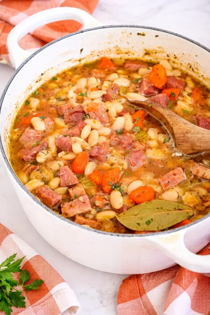 Delicious serving of ham and beans in a bowl with herbs