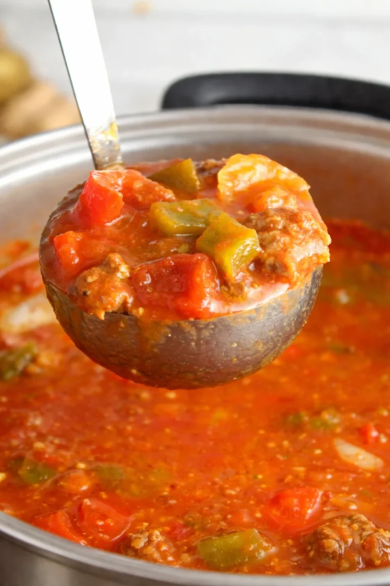 A bowl of hearty stuffed pepper soup with colorful bell peppers and herbs.