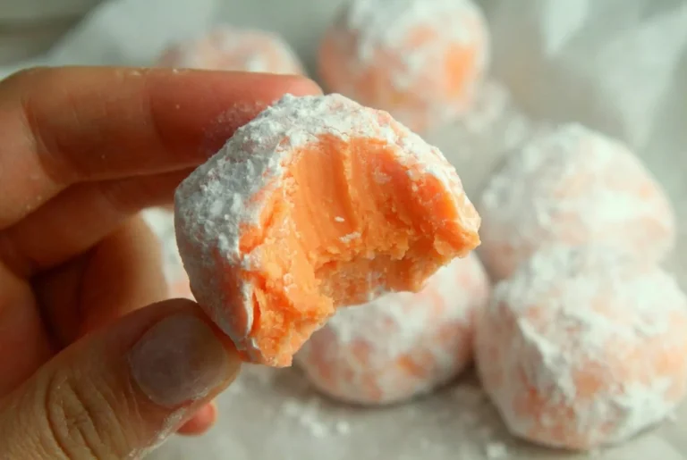 No bake orange creamsicle truffles arranged on a plate.