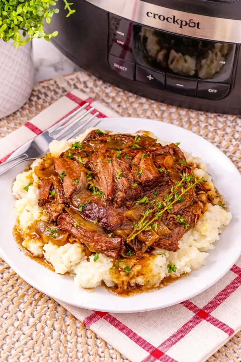 Slow Cooker French Onion Pot Roast served with herbs and vegetables